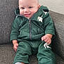 Zavion joined the competition — help win amazing prizes! baby, child, smile, green_tracksuit, socks, couch, indoor, person, happy, seated, fist, head, face, clothing, infant, young_child, expression, casual, texture, background