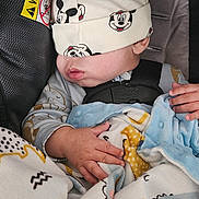 Zavion joined the competition — help win amazing prizes! baby, sleeping, car_seat, mickey_mouse, hat, blanket, dinosaur_pattern, hand, clothing, child, infant, cute, resting, seatbelt, fabric, soft, indoors, warning_label, comfort, peaceful