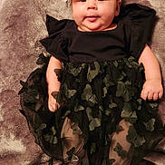 Zella Jo is registered to the contest to win money with this photo: baby, bodypart, clothing, costume, couch, dress, face, finger, furniture, hand, happy, head, newborn, pants, person, photography, portrait, sitting, skirt, smile