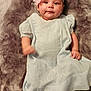 Zella Jo is registered to the contest to win money with this photo: accessories, baby, bodypart, clothing, costume, dress, face, finger, formalwear, happy, hat, head, homedecor, linen, newborn, person, photography, portrait, sitting, smile