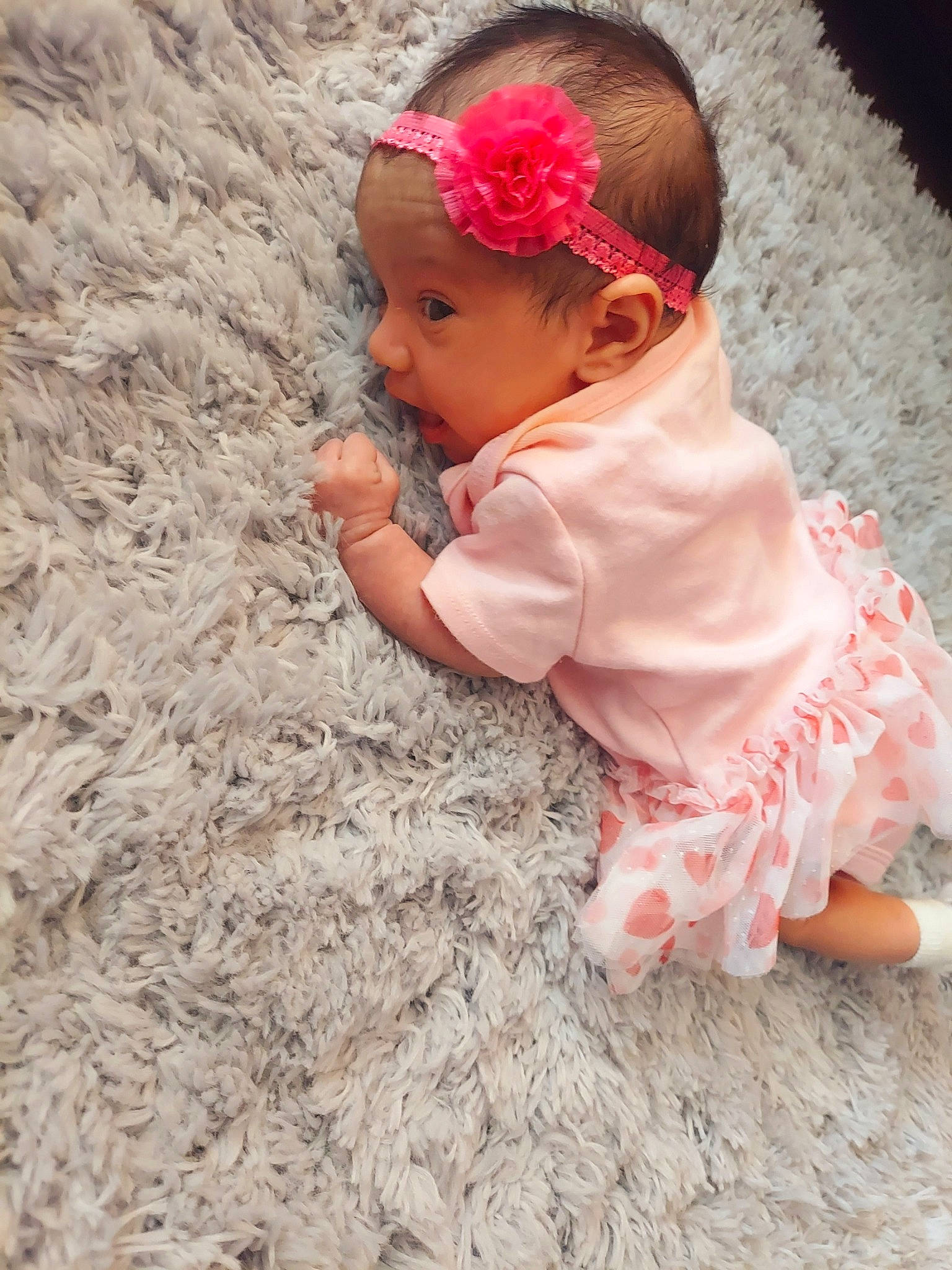 Lynnet is registered to the contest to win money with this photo: baby, baby_toddler_clothing, cap, child, dress, fashion_accessory, flooring, flower, grass, hair_accessory, happy, headband, headgear, headpiece, headwear, magenta, person, petal, pink, skin