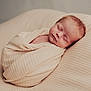 newborn, baby, sleeping, blanket, soft_texture, cushion, peaceful, portrait, infant, wrapped, resting, closeup, head, face, skin, indoors, cozy, calm, warm_tones, child