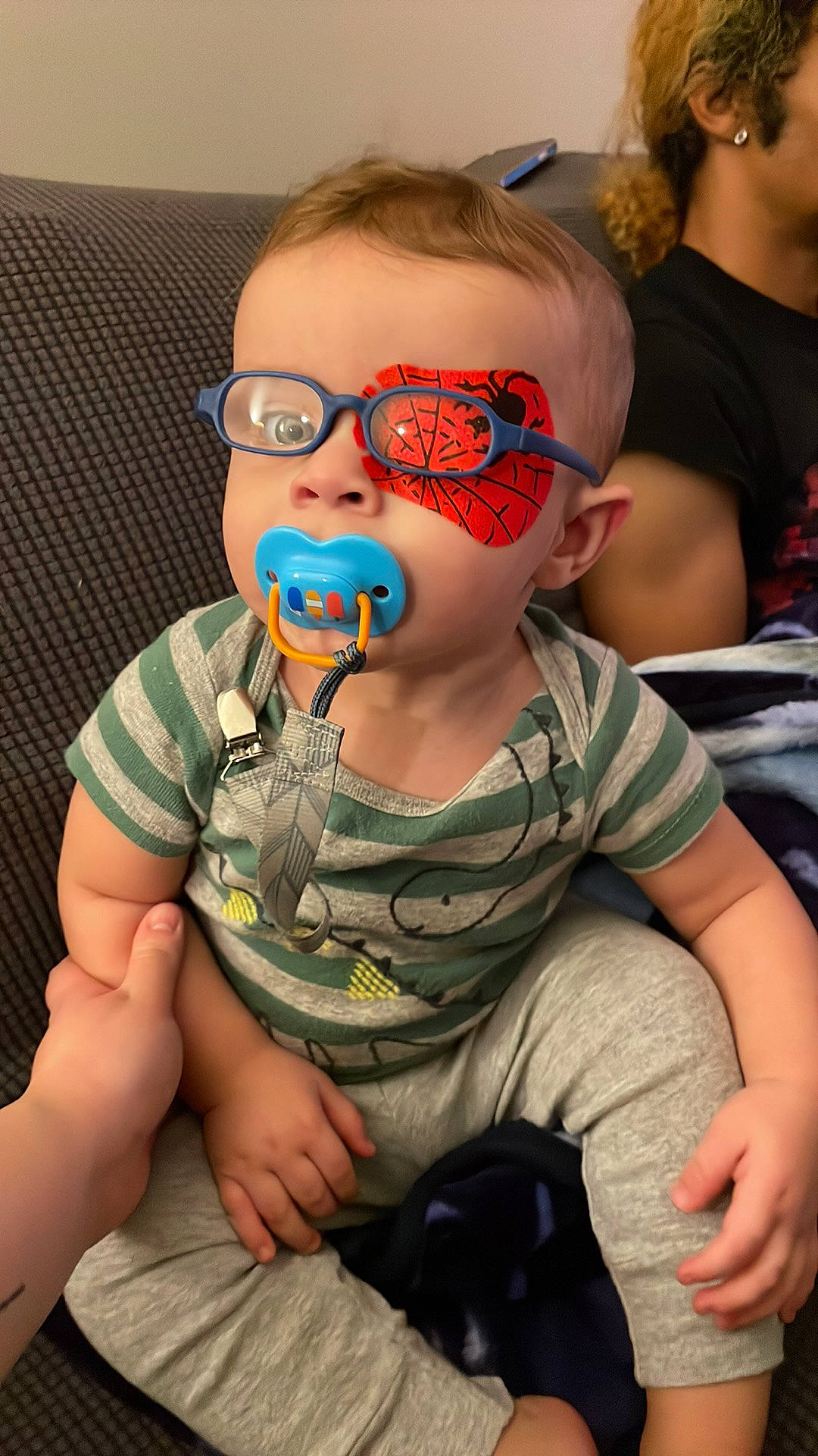 Greyson is registered to the contest to win money with this photo: audio_equipment, baby_toddler_clothing, child, cool, eyewear, fun, goggles, hairstyle, human, jaw, mouth, neck, person, personal_protective_equipment, shoulder, sitting, sleeve, sunglasses, t_shirt, toddler