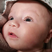 Lyana participe au concours pour gagner de l'argent avec cette photo : adorable, baby, blanket, child, closeup, cute, expression, eyelashes, eyes, face, hood, indoors, infant, looking_up, newborn, portrait, skin, soft, towel, warm_light