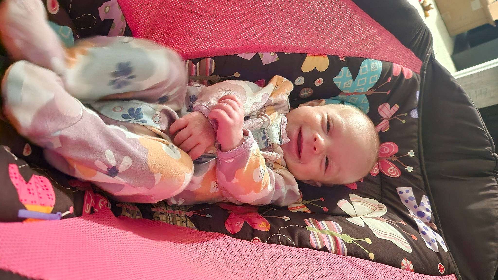 Collins is registered to the contest to win money with this photo: baby, baby_carriage, baby_products, baby_toddler_clothing, car_seat, cheek, child, comfort, head, lap, linens, mammal, pattern, person, pink, room, skin, smile, toddler, vertebrate