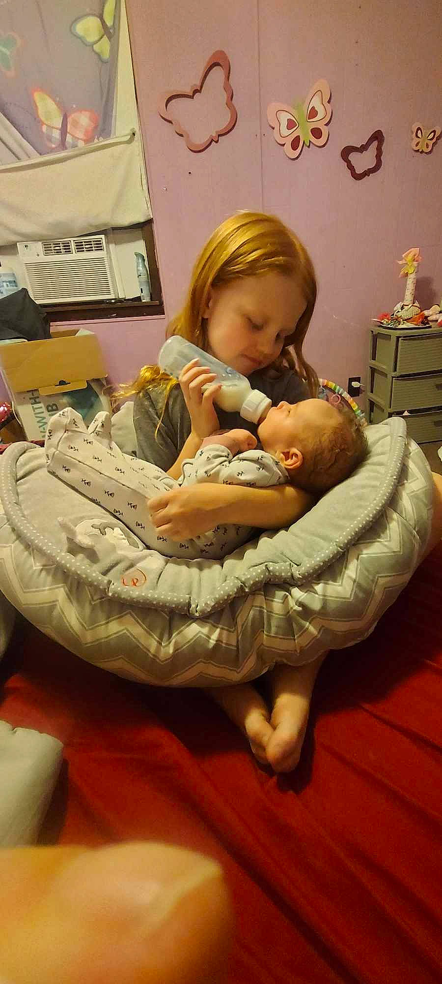 Natalie joined the competition — help win amazing prizes! baby, baby_products, cabinetry, chest_of_drawers, comfort, drawer, dresser, flooring, foot, happy, hardwood, human_leg, lap, linens, person, room, sitting, thigh, toddler, wood