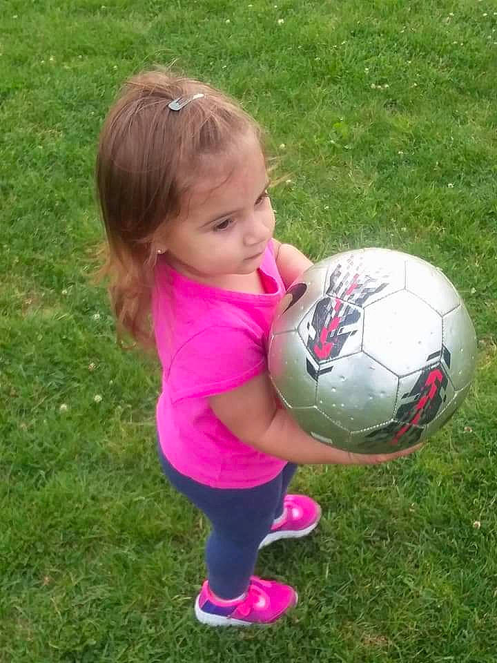 Noel is registered to the contest to win money with this photo: ball, child, football, fun, girl, grass, lawn, pallone, person, pink, plant, play, player, product, purple, sports_equipment, summer, toddler, world