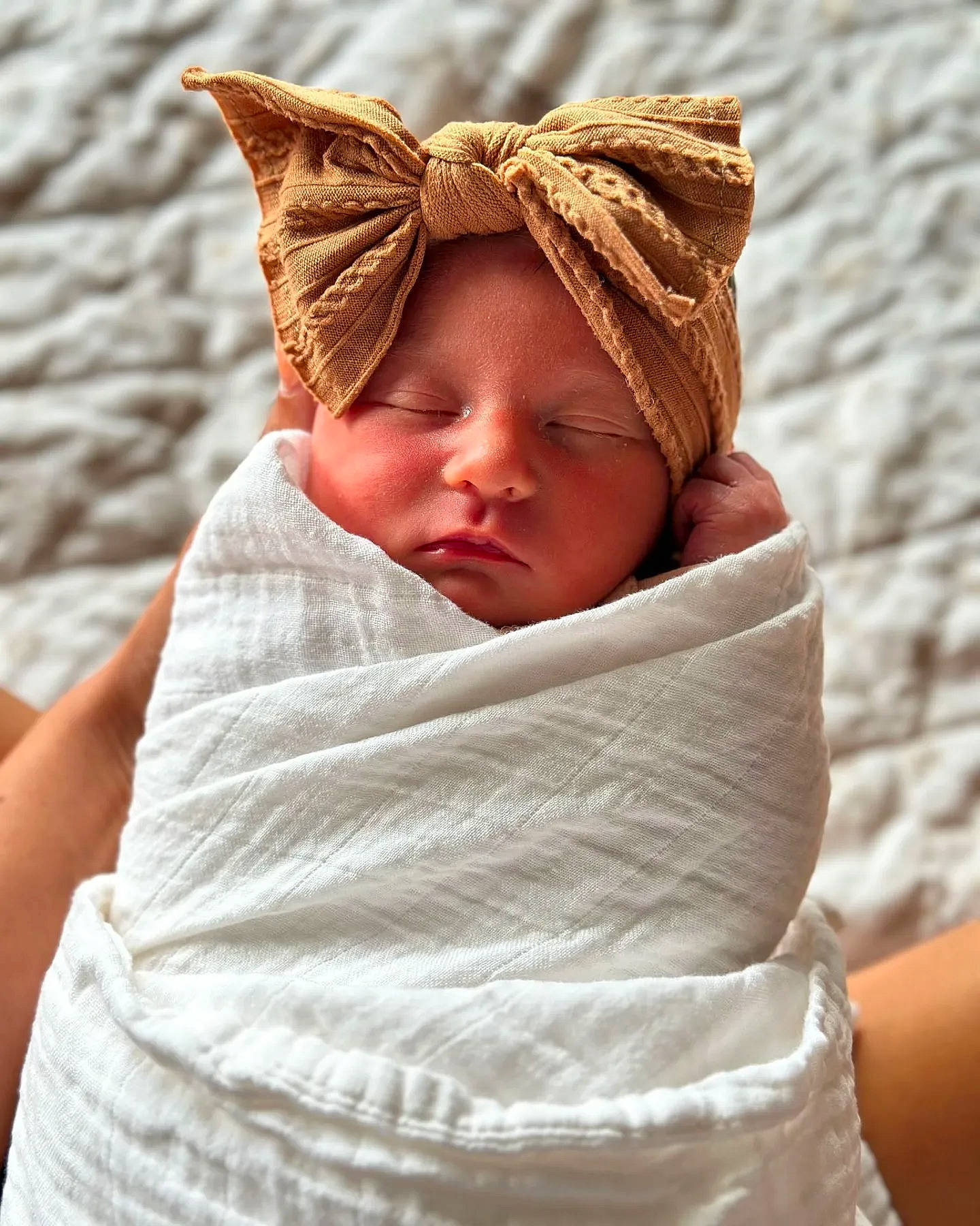 Ivy is registered to the contest to win money with this photo: baby, baby_products, baby_sleeping, baby_toddler_clothing, bedding, cheek, child, comfort, face, fashion_accessory, happy, head, headgear, human_body, linens, person, sitting, sleeve, thumb, toddler