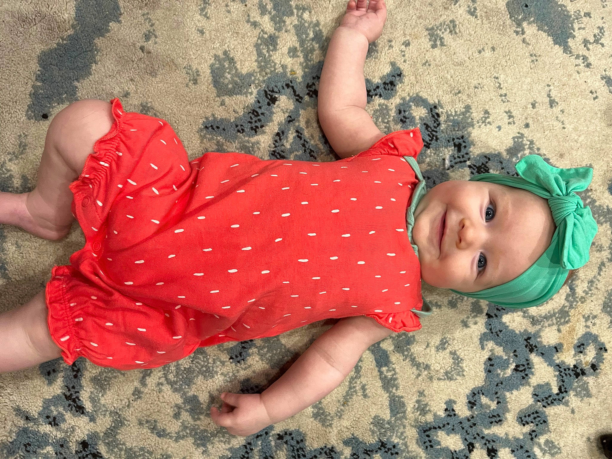 Payton is registered to the contest to win money with this photo: barefoot, beach, child, dress, finger, fun, grass, hand, happy, headwear, human_leg, joy, leisure, pattern, people_in_nature, person, skin, textile, thigh, toddler