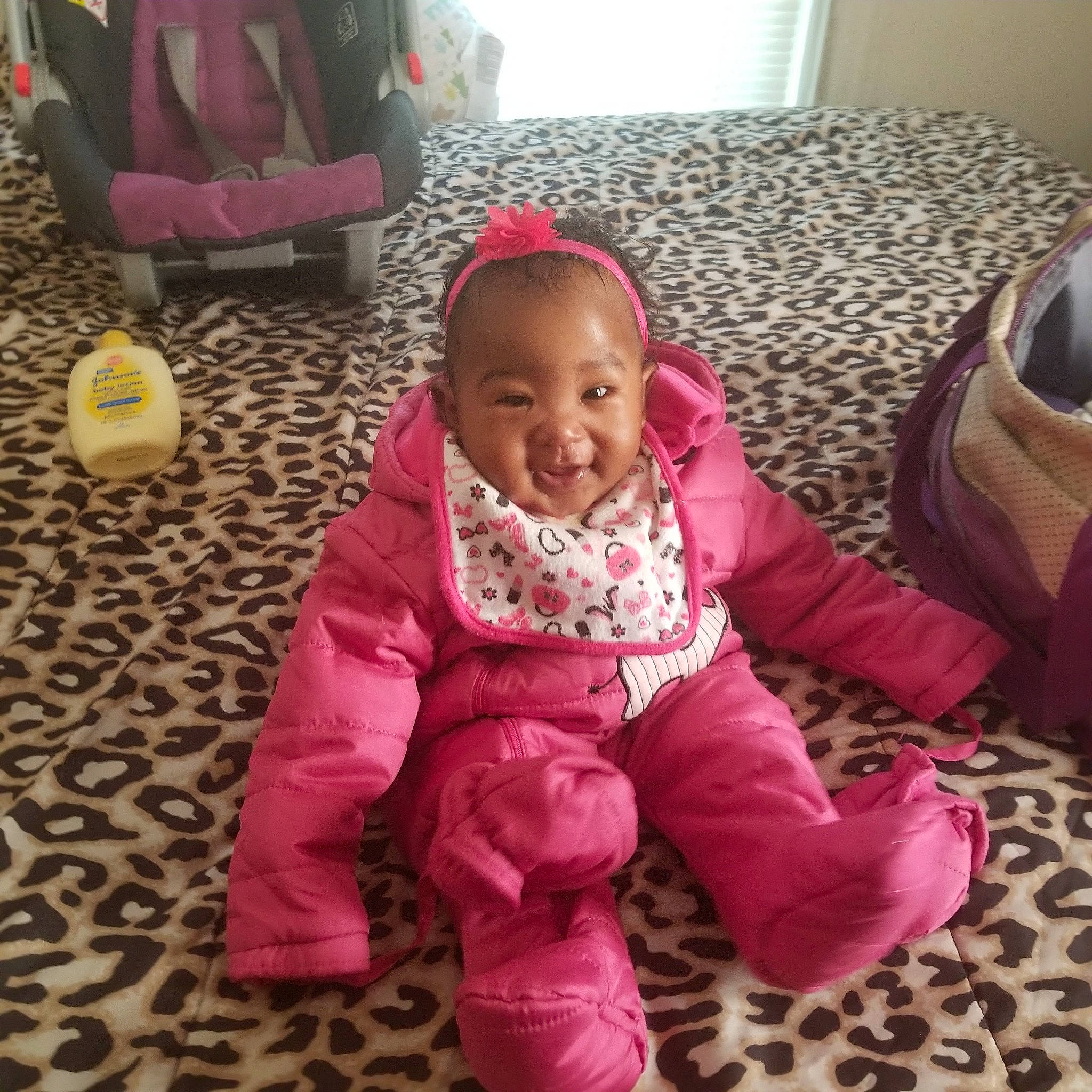 Cali is registered to the contest to win money with this photo: child, day, eye, fun, girl, infant, iris, joy, magenta, outerwear, person, pink, play, product, sitting, skin, smile, textile, toddler