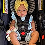 baby, infant, car_seat, yellow_bow, plush_toy, stripes, seatbelt, clothing, cute, child, sitting, hands, legs, foot, headband, soft_toy, safety_harness, portrait, indoors, child_seat