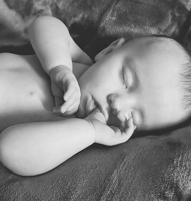 Cora is registered to the contest to win money with this photo: baby, cheek, comfort, eye, eyebrow, eyelash, finger, flash_photography, gesture, grey, hand, head, human_body, iris, lip, mouth, neck, nose, person, skin