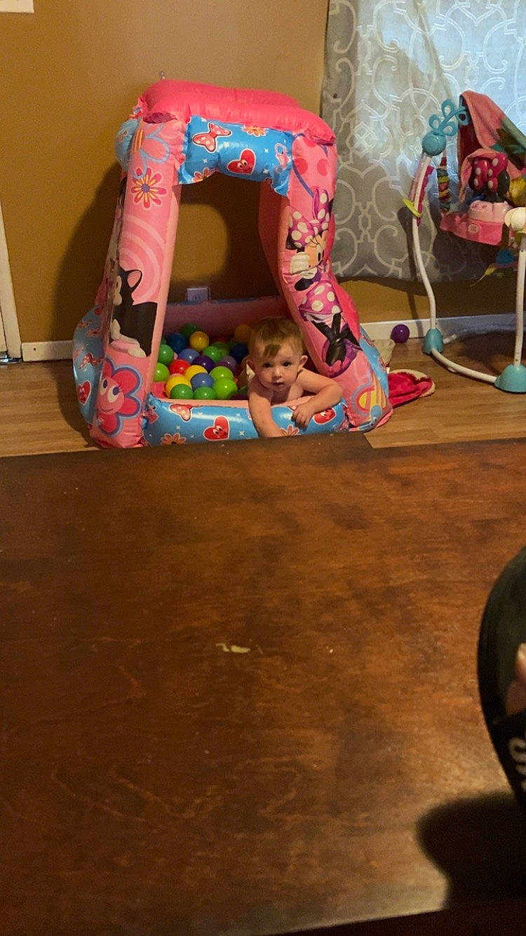 Madelyn is registered to the contest to win money with this photo: arch, art, chair, child, event, flooring, fun, hardwood, human_leg, leisure, magenta, person, pink, plastic, play, room, sitting, toy, visual_arts, wood