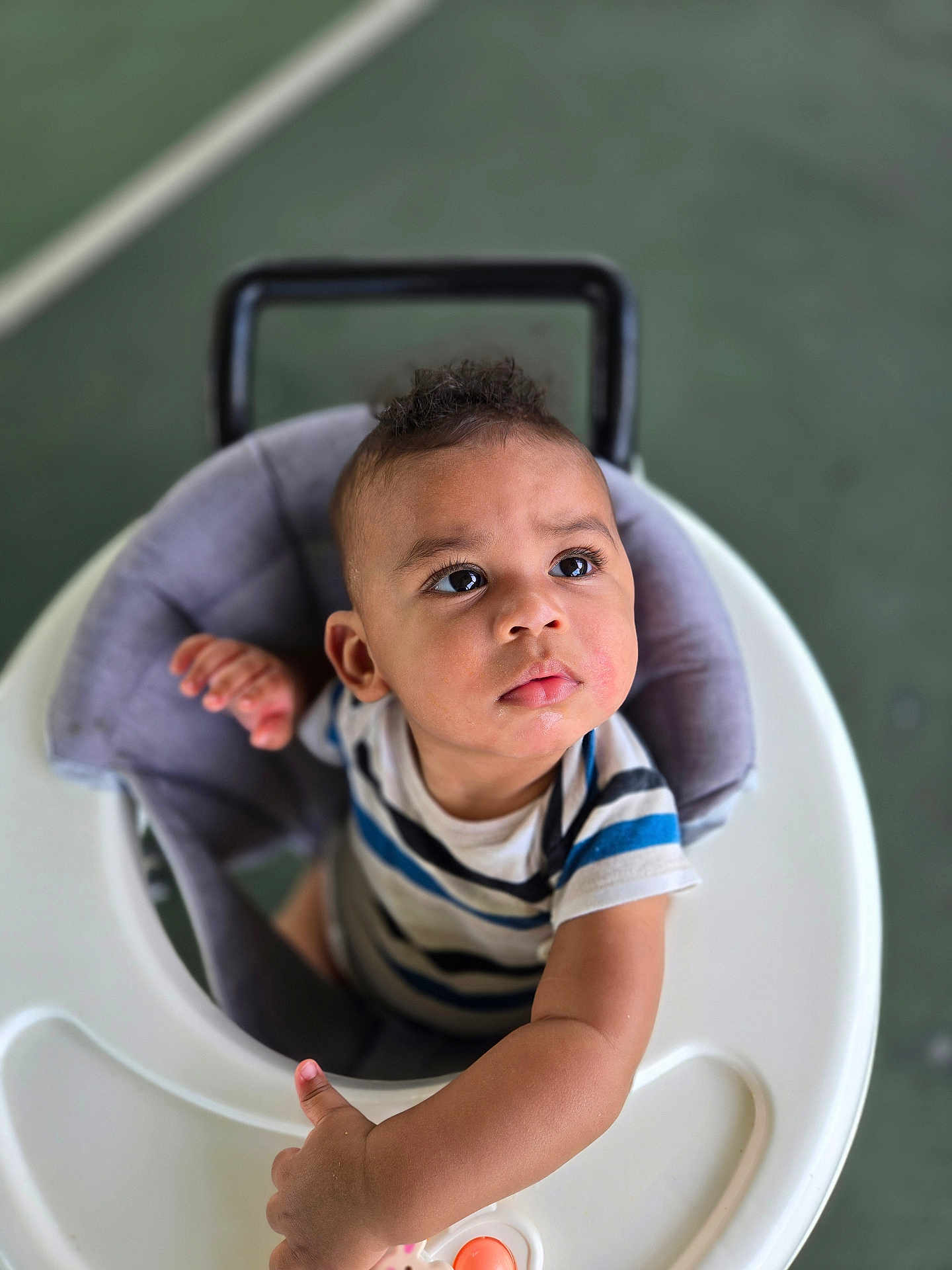 Zayden joined the competition — help win amazing prizes! baby, toddler, child, walker, indoor, curious, striped_shirt, expression, face, arm, seat, toy, hand, person, young_child, infant, looking_up, play, closeup, floor
