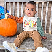 Zayden joined the competition — help win amazing prizes! autumn, bench, brick_wall, casual, child, clothing, colorful, curious, cute, fall, outdoor, person, pumpkin, seat, shoes, sweater, toddler, turkey, wood, young_child