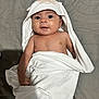 baby, infant, towel, hooded_towel, cute, smiling, face, skin, arm, blanket, lying_down, indoors, child, person, fabric, soft, comfort, warm, expression, bed