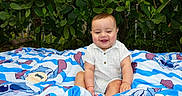 Thiago joined the competition — help win amazing prizes! baby, child, smiling, blanket, outdoor, greenery, foliage, happy, cute, sitting, clothing, nature, infant, portrait, playful, young, person, colorful, daylight, grass