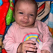 Maddox joined the competition — help win amazing prizes! baby, infant, child, portrait, face, eyes, pink_outfit, rainbow, blanket, colorful, cozy, lying_down, indoors, head, hands, cuddly, cute, calm, close_up, photography