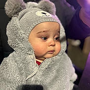 George joined the competition — help win amazing prizes! baby, child, face, portrait, hat, costume, plush, fuzzy, warm_clothing, pom_poms, cute, indoors, soft_texture, young_child, winter_wear, expression, person, apparel, headwear, adorable
