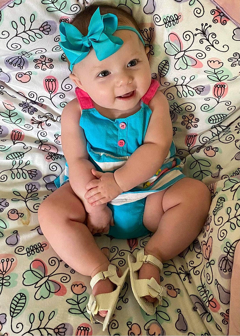 Eleanor joined the competition — help win amazing prizes! aqua, baby, baby_toddler_clothing, cheek, child, face, hairstyle, happy, headwear, human_leg, leg, nail, pattern, person, pink, purple, skin, sleeve, smile, textile