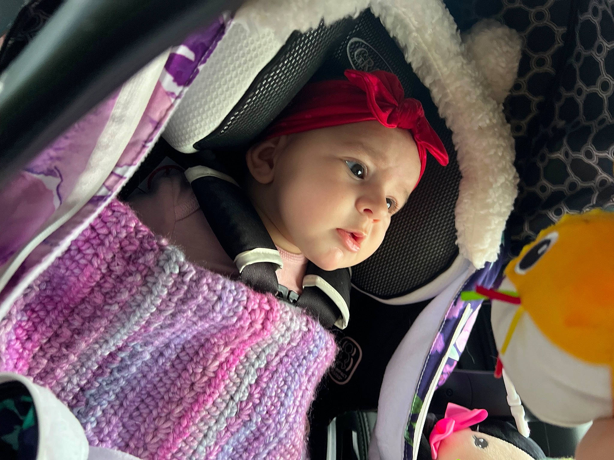 Aspen is registered to the contest to win money with this photo: auto_part, baby, baby_carriage, baby_products, cap, car_seat, cheek, child, comfort, cool, fun, happy, headwear, lip, outerwear, person, product, purple, skin, steering_wheel