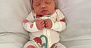 Lillian is registered to the contest to win money with this photo: baby, newborn, sleeping, onesie, headband, pink_bow, infant, cute, cozy, soft, cushion, white_background, peaceful, closed_eyes, small_hands, portrait, indoors, resting, child, adorable