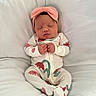 baby, newborn, sleeping, onesie, headband, pink_bow, infant, cute, cozy, soft, cushion, white_background, peaceful, closed_eyes, small_hands, portrait, indoors, resting, child, adorable