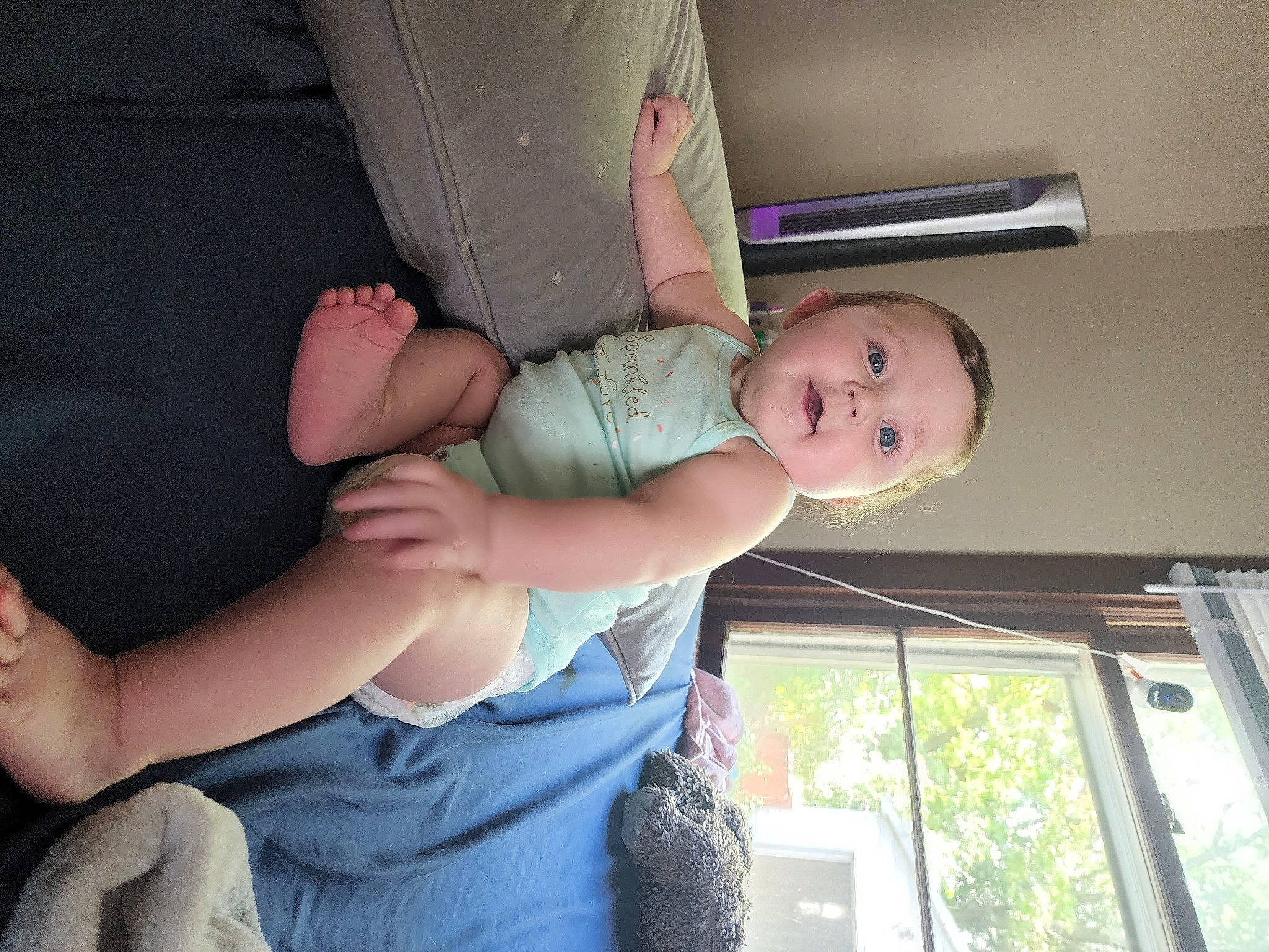Elara is registered to the contest to win money with this photo: baby, baby_products, baby_toddler_clothing, child, comfort, dress, elbow, finger, fun, gesture, glasses, happy, joint, leg, person, shoulder, sitting, smile, thigh, toddler