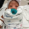 Royalynn is registered to the contest to win money with this photo: newborn, baby, pacifier, hospital, blanket, hat, bow, infant, wrapped, bed, person, portrait, cute, hospital_room, footprints, swaddled, child, hand, medical, patient