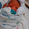 Royalynn is registered to the contest to win money with this photo: newborn, baby, pacifier, blanket, headband, hospital_bed, wrapped, infant, footprint_pattern, cute, sleepy, person, tiny, cozy, baby_clothes, hospital, bed, hand, comfort, portrait