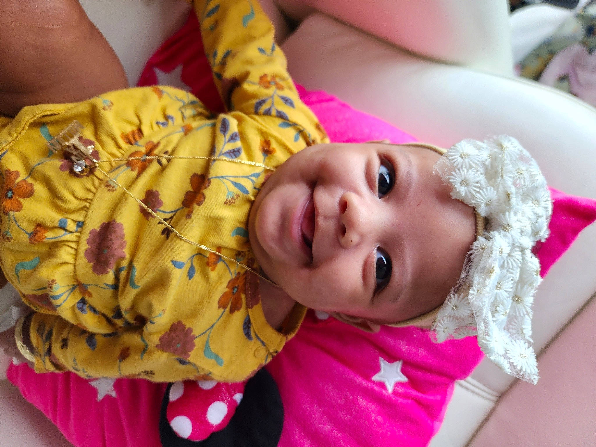 Annalise is registered to the contest to win money with this photo: baby, baby_toddler_clothing, cheek, child, eyelash, face, facial_expression, happy, head, human, joy, lip, mammal, neck, nose, person, pink, skin, smile, textile