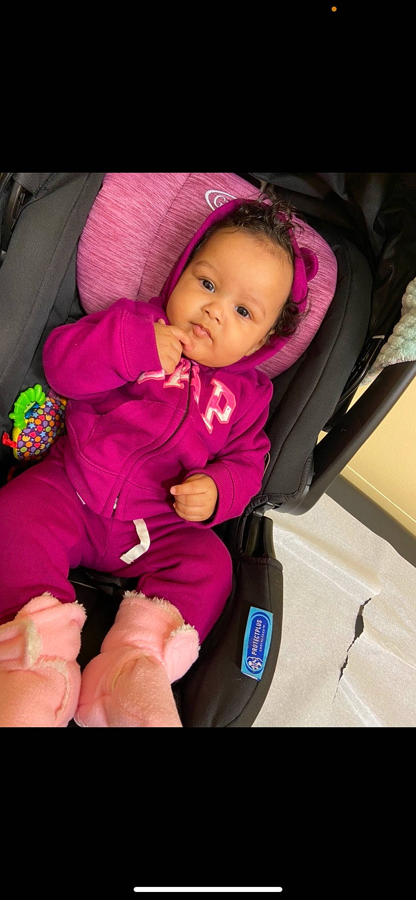 Kamryn is registered to the contest to win money with this photo: baby, baby_carriage, baby_in_car_seat, baby_products, baby_safety, baby_toddler_clothing, car_seat, cheek, child, comfort, eye, finger, fun, lap, magenta, person, pink, purple, sitting, sleeve