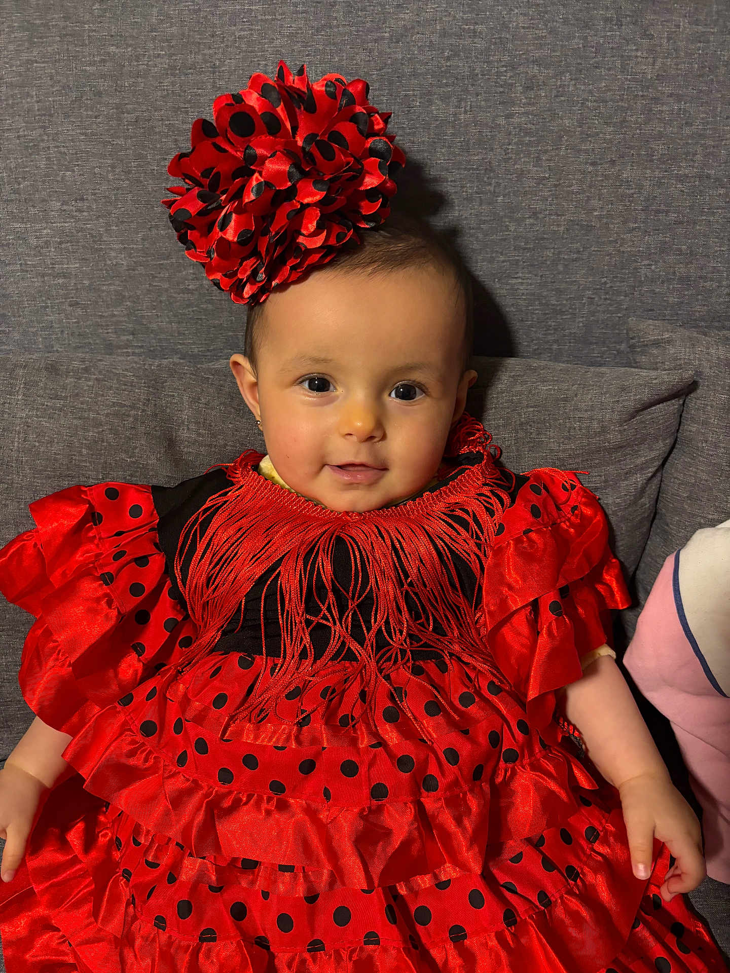 Sianna participe au concours pour gagner de l'argent avec cette photo : baby, child, dress, red, black, polka_dot, headpiece, smile, face, sitting, couch, indoor, cute, portrait, person, infant, fashion, colorful, adorable, young