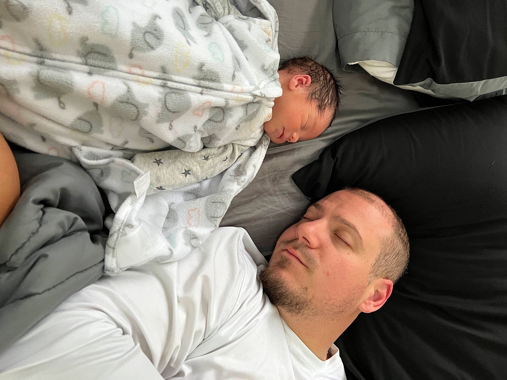 Jesse is registered to the contest to win money with this photo: abdomen, baby, baby_products, baby_sleeping, bedding, bedtime, child, comfort, elbow, event, gesture, interaction, joint, knee, linens, nap, pattern, person, room, sitting