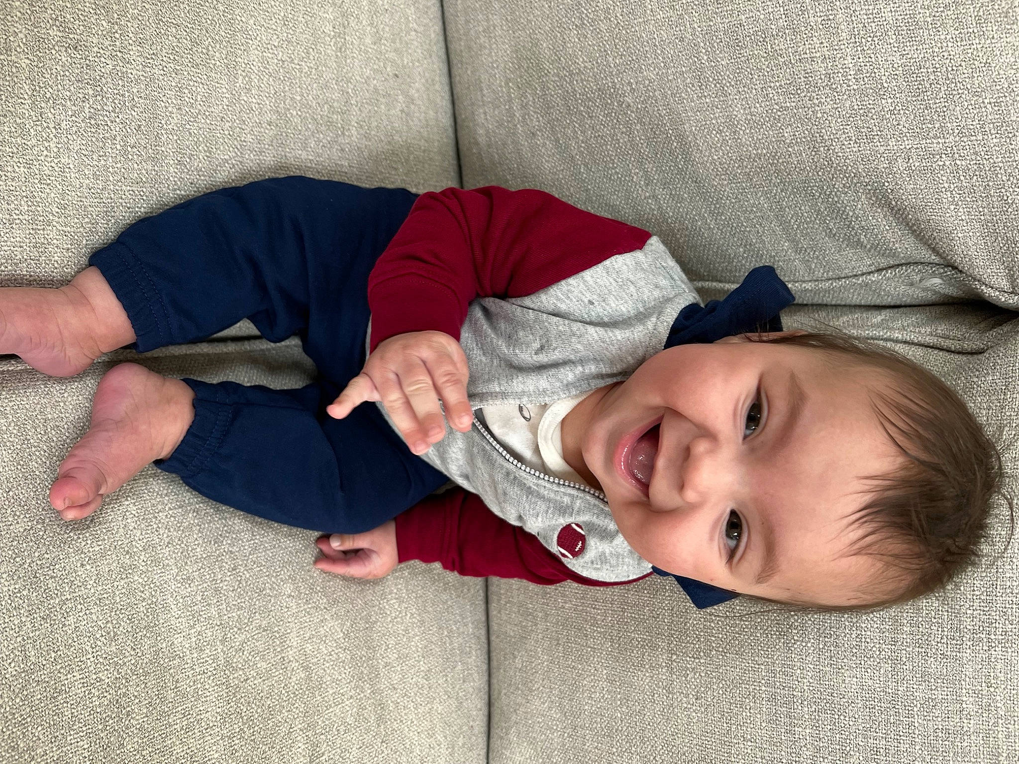 Jesse is registered to the contest to win money with this photo: baby_toddler_clothing, carmine, cheek, child, comfort, flooring, foot, grass, human_leg, knee, linens, lip, mammal, nose, person, skin, sleeve, smile, textile, toddler