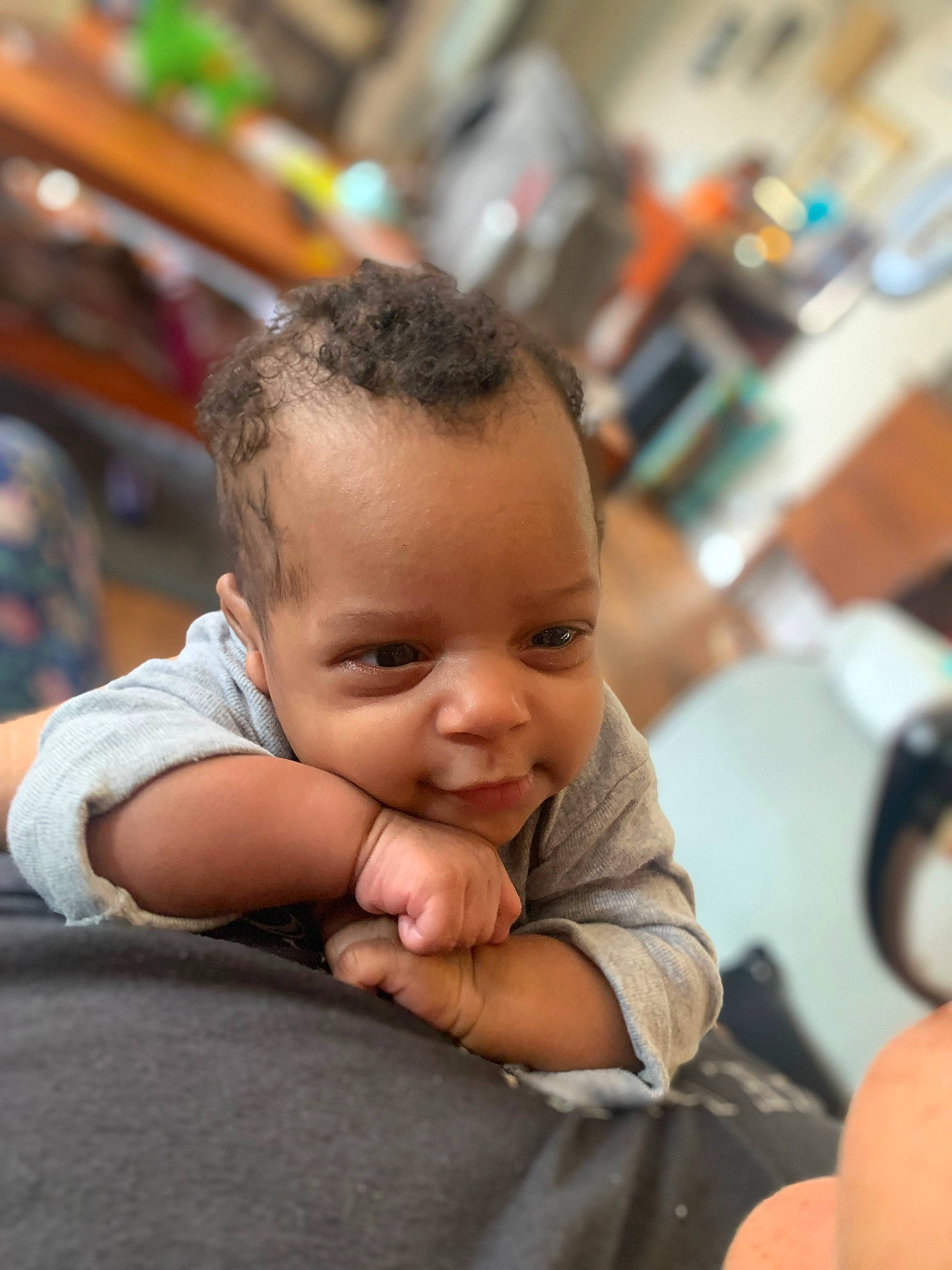 Mariah is registered to the contest to win money with this photo: baby, cheek, child, finger, flooring, fun, gesture, happy, leisure, nose, person, room, sitting, skin, smile, thumb, toddler