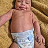 baby, diaper, smiling, lying_down, blanket, infant, child, skin, cute, happy, portrait, hand, face, young, newborn, expression, relaxed, indoors, toddler, person