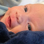 Alexis joined the competition — help win amazing prizes! baby, newborn, infant, face, eyes, eyelashes, cheek, nose, mouth, lips, blanket, blue_blanket, swaddle, close_up, portrait, skin, gaze, cozy, soft_texture, adorable