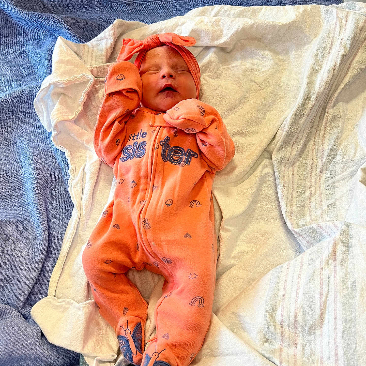 Lyric is registered to the contest to win money with this photo: newborn, baby, sleeping, orange_onesie, headband, blanket, blue_blanket, white_blanket, infant, cozy, cute, resting, child, soft_texture, indoor, footed_pajamas, peaceful, small, person, portrait
