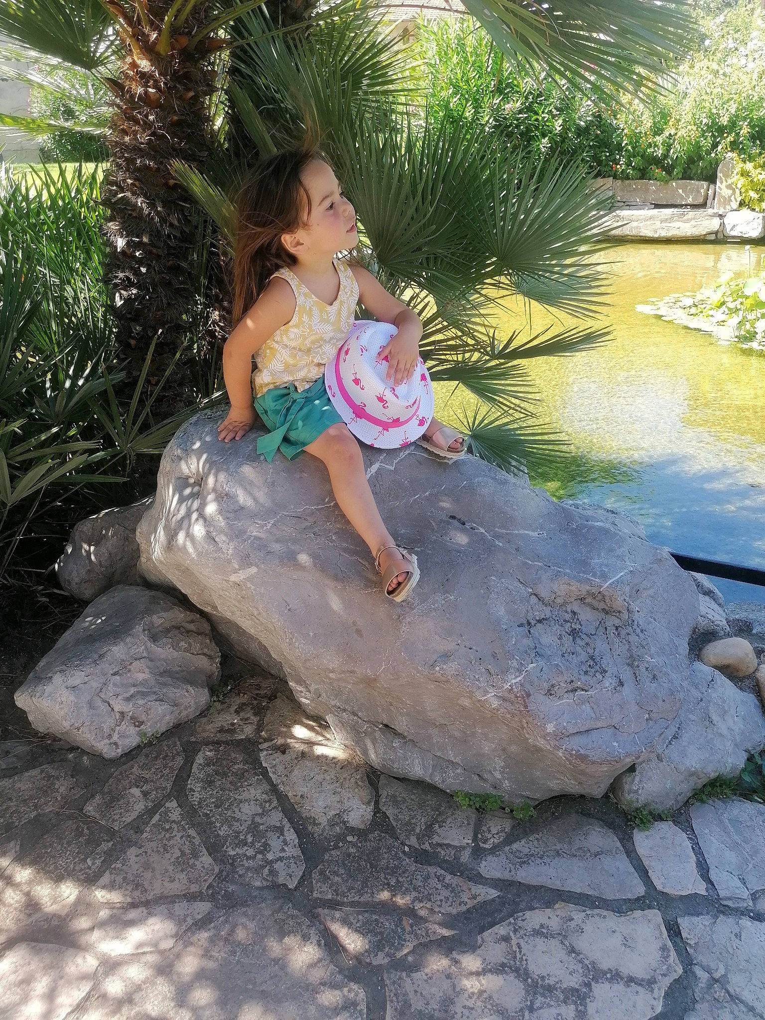 Aline participe au concours pour gagner de l'argent avec cette photo : arecales, barefoot, child, dress, foot, fun, garden, grass, happy, landscape, leg, leisure, people_in_nature, person, plant, recreation, sandal, thigh, toddler, tree