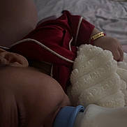 Brayden joined the competition — help win amazing prizes! baby, infant, sleeping, red_outfit, white_teddy_bear, stuffed_animal, pacifier, blanket, bed, bedroom, cozy, dim_lighting, closeup, baby_clothing, wristband, plush_toy, cuddling, resting, indoor, portrait