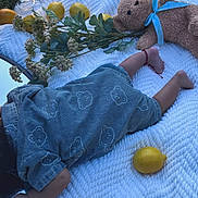 Brayden joined the competition — help win amazing prizes! baby, infant, sleeping, blanket, teddy_bear, lemons, lemonade, juice, picnic, outdoor, grass, flowers, floral, blue_blanket, dress, socks, feet, lying_down, still_life, cozy