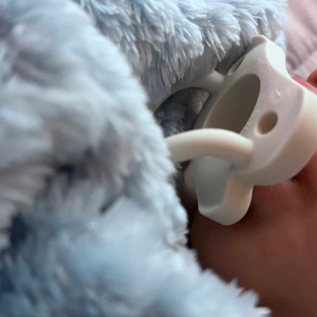Brayden is registered to the contest to win money with this photo: baby, infant, pacifier, blanket, fluffy, blue, sleeping, cozy, close_up, portrait, nursery, soft, textile, bedding, snuggling, indoors, comfort, child, pastel, peaceful
