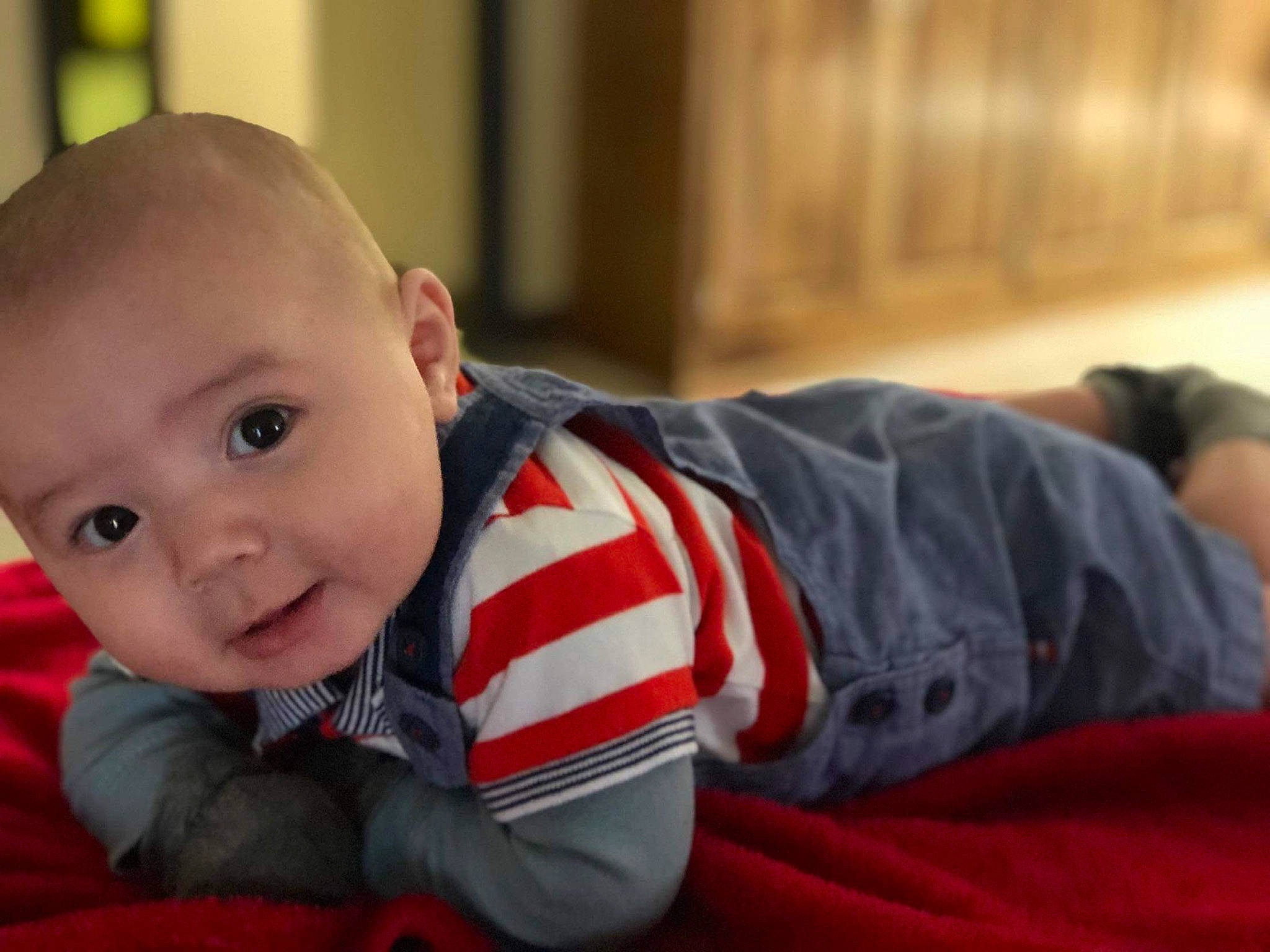 M-jay is registered to the contest to win money with this photo: arm, baby, cheek, child, chin, crawling, ear, eye, face, head, iris, mouth, nose, person, sitting, skin, smile, toddler, tummy_time