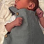 Luca is registered to the contest to win money with this photo: baby, infant, newborn, blanket, hand, clothing, button, person, skin, face, ear, sleepwear, soft, cute, small, protection, lying_down, indoors, fabric, expression