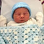 newborn, baby, sleeping, blanket, crocheted_blanket, blue_hat, knit_hat, bassinet, hospital, infant, cozy, cute, peaceful, soft, warm, clothing, person, portrait, resting, child