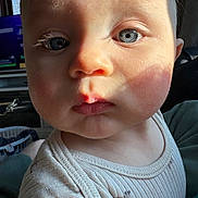 Ezra joined the competition — help win amazing prizes! child, baby, infant, face, eyes, blue_eyes, close_up, portrait, skin, cheeks, lips, nose, sunlight, shadow, shirt, onesie, indoor, couch, eyelashes, expression