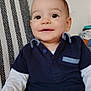 Léo participe au concours pour gagner de l'argent avec cette photo : baby, child, smiling, face, eyes, clothing, shirt, pants, sitting, chair, patterned, indoor, cute, happy, portrait, young, person, light, casual, comfortable