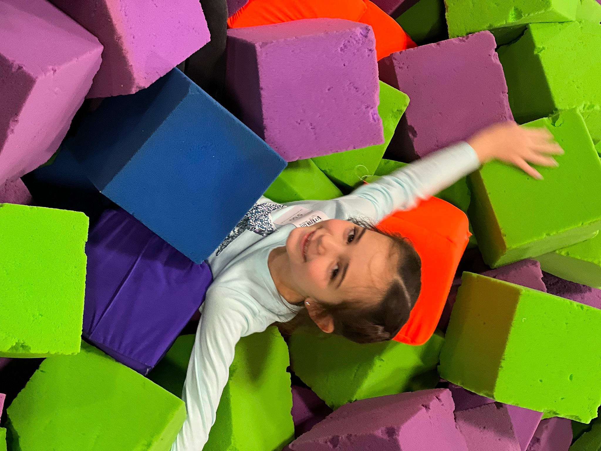 Layla is registered to the contest to win money with this photo: art, automotive_wheel_system, event, fun, grass, green, happy, joy, leisure, magenta, paper, paper_product, pattern, person, public_event, smile, social_group, visual_arts, yellow, youth