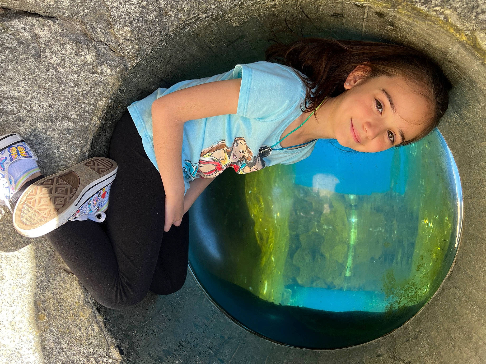 Layla is registered to the contest to win money with this photo: azure, ball, child, cool, electric_blue, eye, flash_photography, fun, grass, happy, helmet, human_leg, joy, leisure, people_in_nature, person, recreation, sitting, smile, sports_equipment